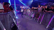 a crowd of people are standing in front of a stage with the word dakota on it