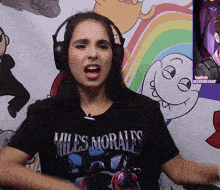 a woman wearing headphones and a shirt that says miles morales on it