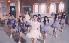 a group of girls are dancing in a room with a sign that says way out