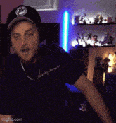 a man wearing headphones and a black shirt that says imgflip.com on the bottom right