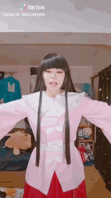 a woman in a pink and red outfit has a tiktok id