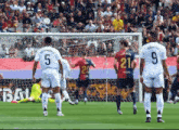 a soccer player wearing a number 21 jersey stands on the field