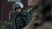 a police officer wearing a helmet with a visor and a badge that says ' tactical '