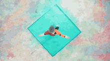 an aerial view of a person falling into the water