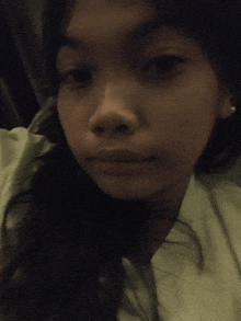 a close up of a girl 's face with a serious expression