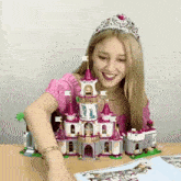 a woman wearing a tiara is building a lego castle