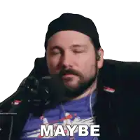 a man with a beard is sitting in front of a microphone and the word maybe is visible