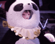 a stuffed panda bear with a girl in it