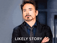 a man in a suit and tie is standing with his arms crossed and the words `` likely story '' behind him .