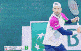 a tennis player holds a racket in front of a scoreboard that says dimitrov monfils on it