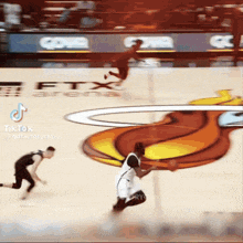 a basketball game is being played in front of a logo for ftx arena