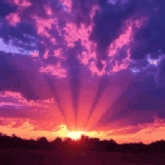 the sun is shining through the clouds at sunset .