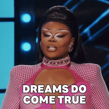 a drag queen says dreams do come true in a pink outfit