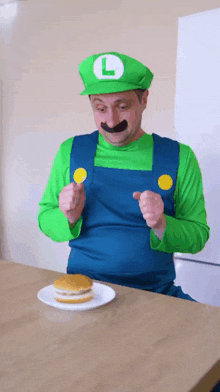 a man dressed as luigi is eating a hamburger on a plate
