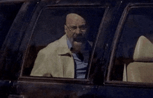 a man with a beard is driving a car and screaming .
