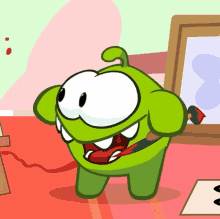 a green cartoon character is holding a red brush