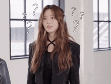 a woman is surrounded by question marks and looks confused