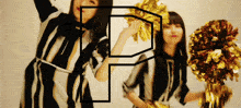 two cheerleaders are holding pom poms in front of a letter p