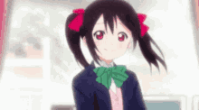 a girl with pigtails and a green bow tie is wearing a school uniform and smiling .