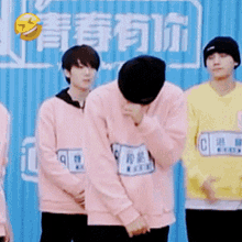 a group of young men wearing pink sweaters and yellow sweaters