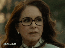 a close up of a woman wearing glasses with the hashtag lialmeida05 below her