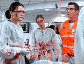 a man wearing an orange vest that says emergency