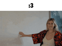 a woman stands in front of a white board with the number 3 written on it