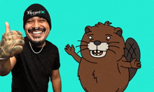 a man wearing a beanie that says blizzard giving a thumbs up next to a cartoon beaver
