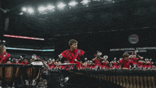 a marching band is performing in front of a sign that says grand national champions
