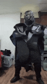 a person in a costume is standing on a wooden floor in a room