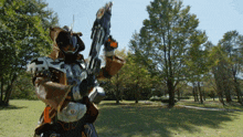 a man in a cowboy costume is holding a large sword in a park
