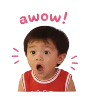 a little boy with a surprised look on his face is wearing a red tank top with the word wow on it