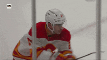 a hockey player wearing a red and white jersey with the number 23 on it