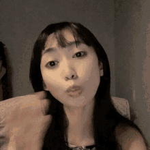 a woman making a funny face with her hand