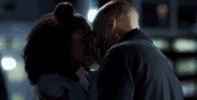 a man and a woman are kissing in the dark in a dark room .