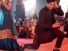 a man and a woman are dancing on a stage