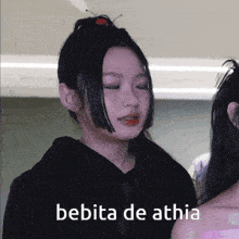 a girl with a ponytail and the words bebita de athia on the bottom