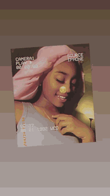 a picture of a girl with a pink scarf around her head taken on october 27 1992