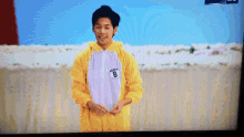 a man wearing a yellow and white outfit with the number 8 on it
