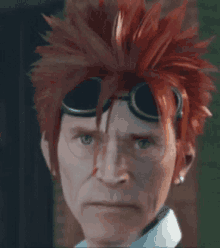 a close up of a man 's face with red hair and goggles .