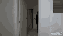 a person standing in a hallway with the words made in animotica on the bottom right