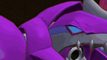 a close up of a red and purple robot with a yellow light coming out of it 's chest .