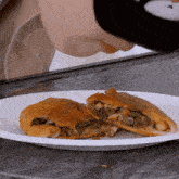 a person is eating a pastry on a plate