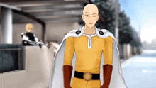 a bald man in a yellow and white superhero costume stands on a street