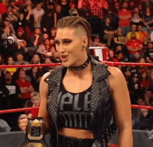 a woman in a wrestling ring holding a wwe championship