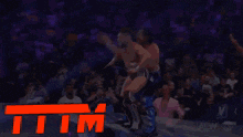 two men are wrestling in a ring and the word tim is on the bottom of the image
