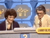 a man and a woman are playing a game show and the man is named larry beve .
