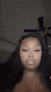 a woman with long pink nails is cutting her hair with scissors .
