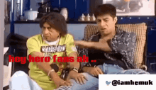 two men are sitting on a couch with the words hey hero fans ah written in red