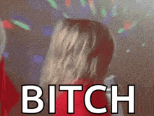 a woman in a red dress is dancing with the word bitch in front of her